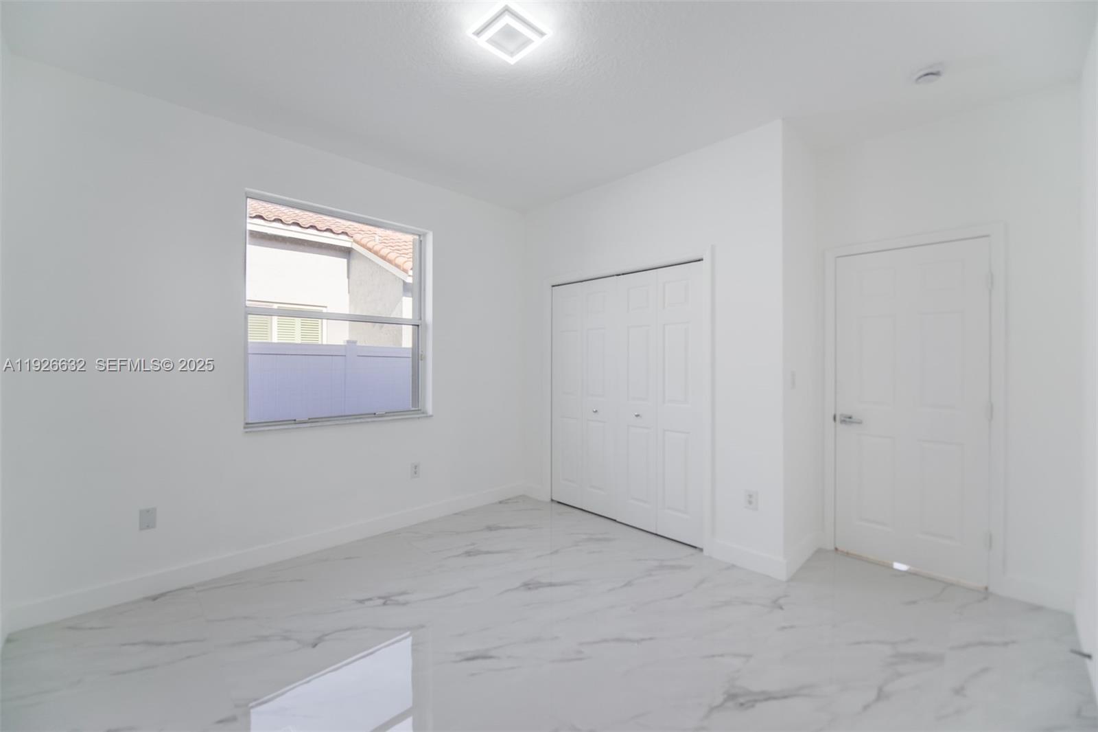 5290 Southwest 134th Avenue Miramar, FL 33027 - Photo 24 of 44 an empty room with windows