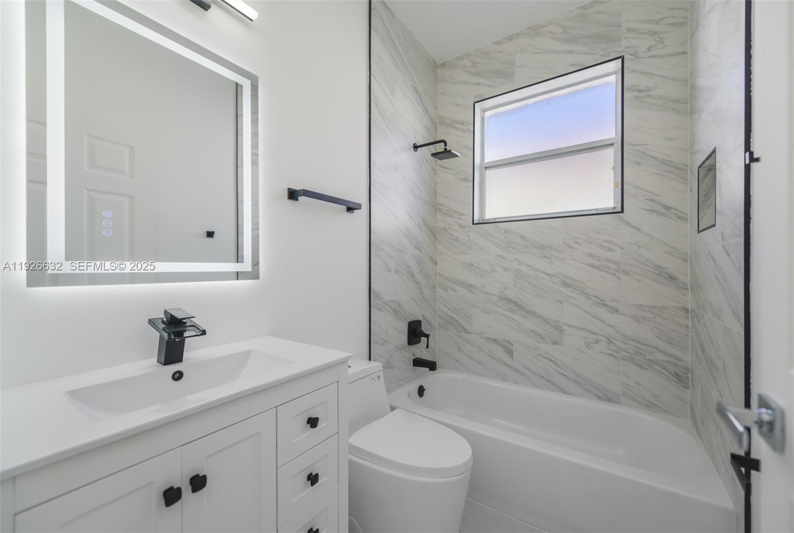 5290 Southwest 134th Avenue Miramar, FL 33027 - Photo 27 of 44 a bathroom with a sink a toilet and shower