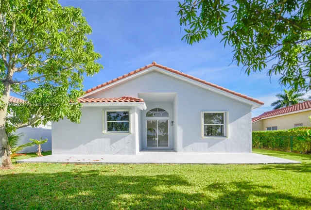 a front view of multi story residential apartment building with yard