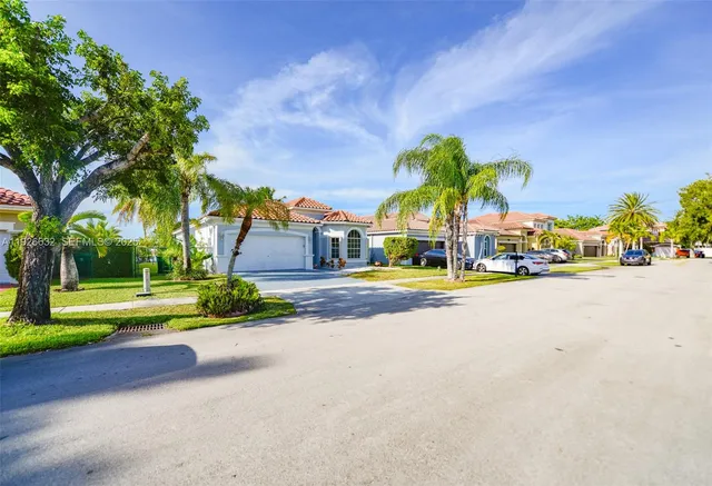 a view of a house with a yard and a garden