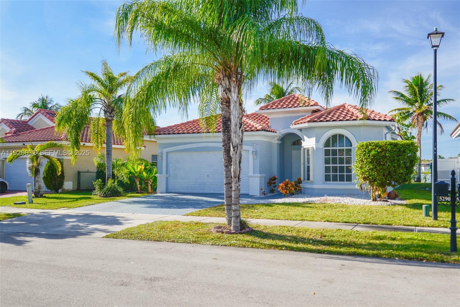 5290 Southwest 134th Avenue Miramar, FL 33027 - Photo 39 of 44 a front view of house with yard and green space