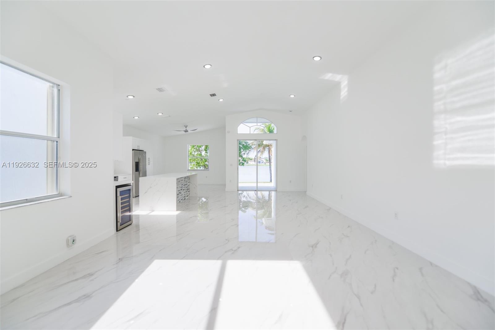5290 Southwest 134th Avenue Miramar, FL 33027 - Photo 4 of 44 a view of a hallway with wooden floor windows and a living room