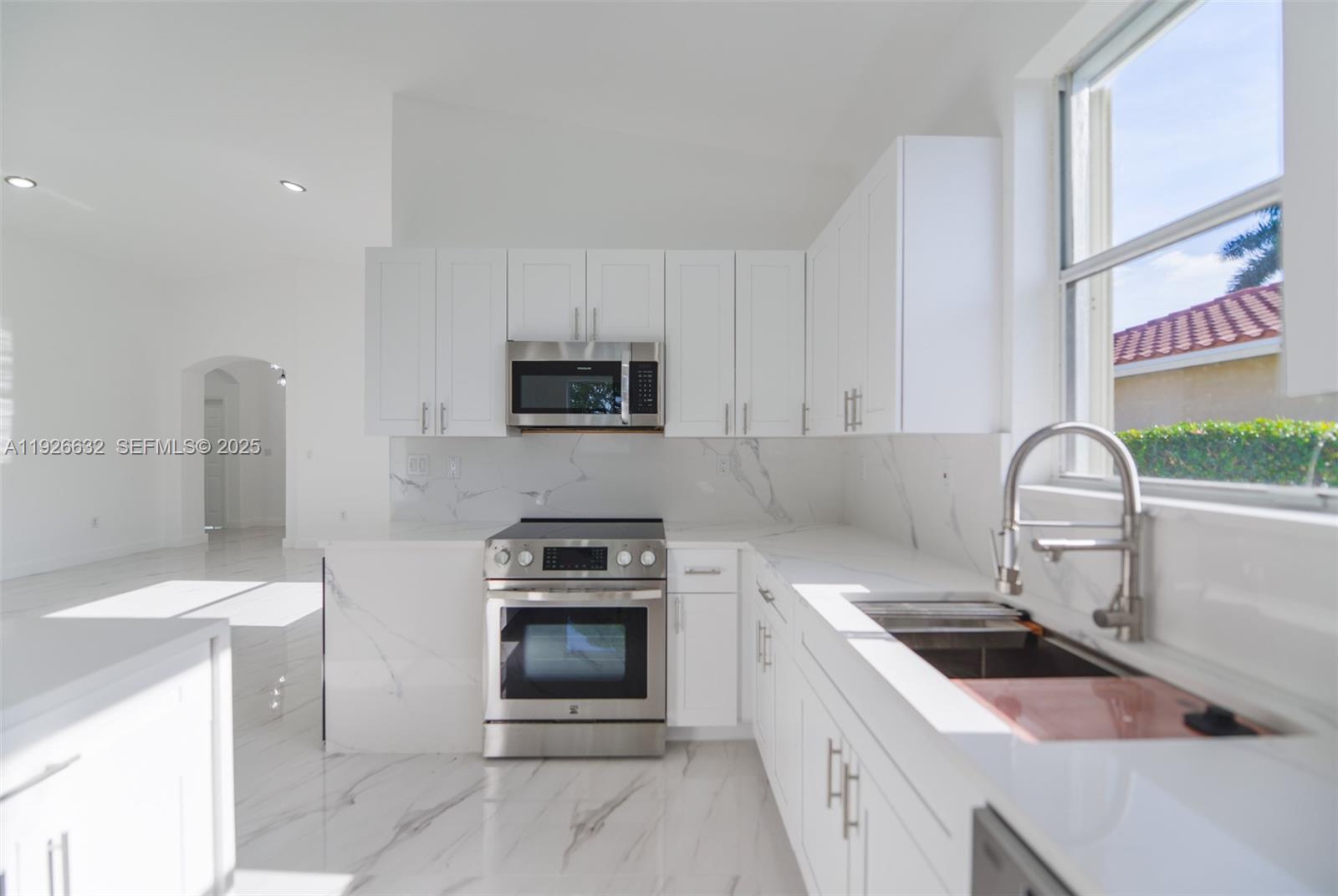 5290 Southwest 134th Avenue Miramar, FL 33027 - Photo 9 of 44 a kitchen with a sink stove and cabinets
