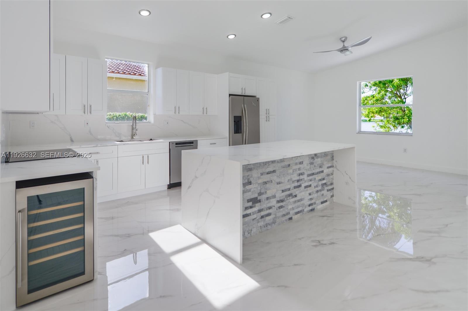 5290 Southwest 134th Avenue Miramar, FL 33027 - Photo 10 of 44 a bathroom with a granite countertop sink a vanity a window and a bathtub