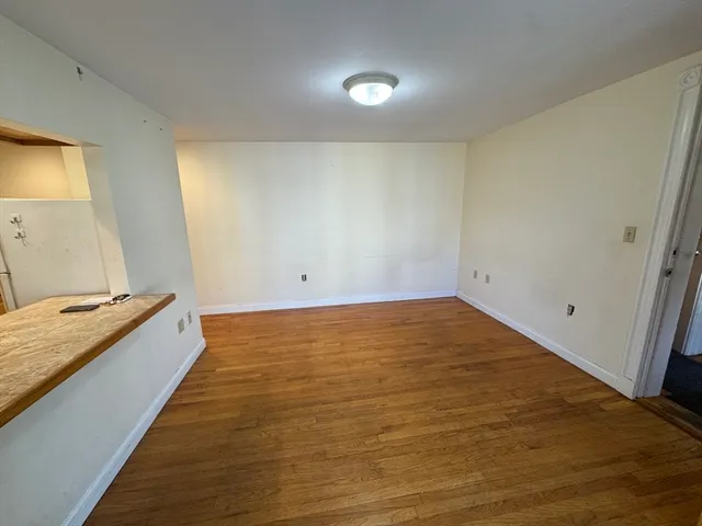 a view of an empty room and wooden floor