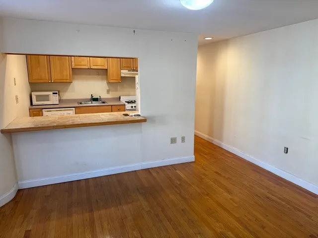 a view of room with wooden floor and window