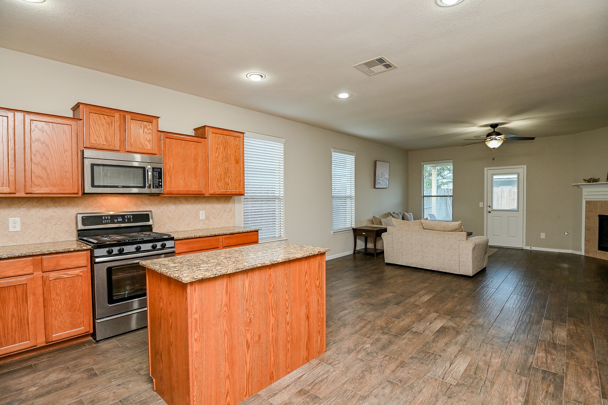 15406 Key Crest Lane Cypress, TX 77429 - Photo 15 of 47 a kitchen with stainless steel appliances granite countertop a stove a sink and a refrigerator