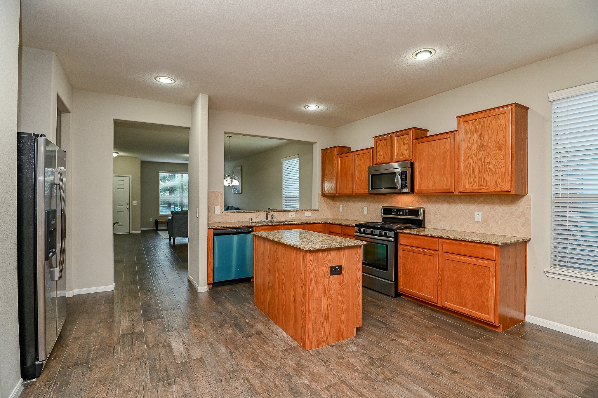 15406 Key Crest Lane Cypress, TX 77429 - Photo 16 of 47 a large kitchen with stainless steel appliances granite countertop a stove and a sink