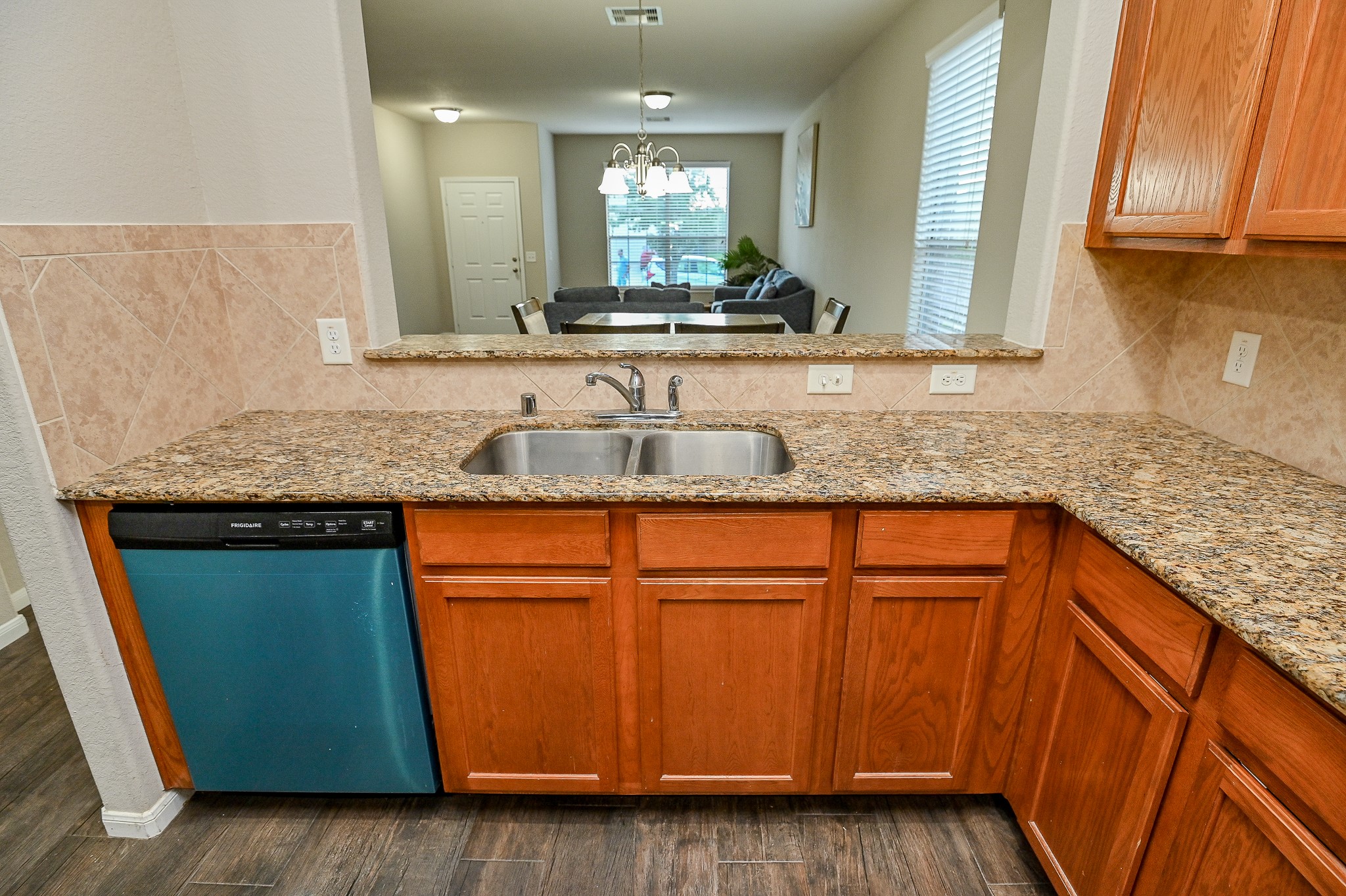 15406 Key Crest Lane Cypress, TX 77429 - Photo 18 of 47 a kitchen with granite countertop wooden cabinets and a sink