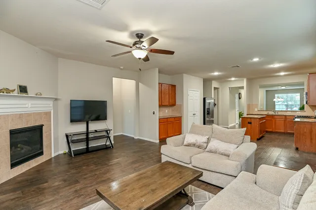 a living room with furniture fireplace and flat screen tv