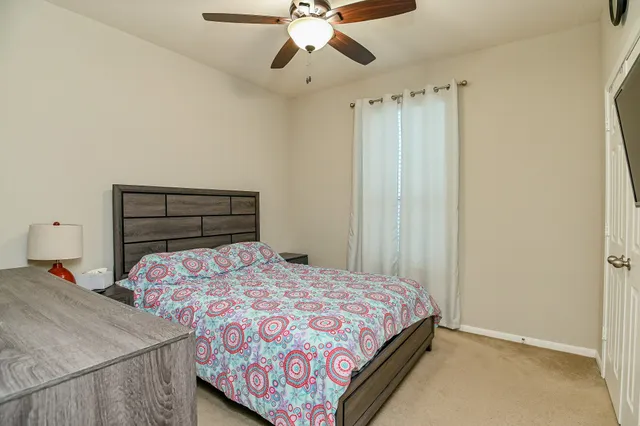 a bedroom with a bed and a chandelier