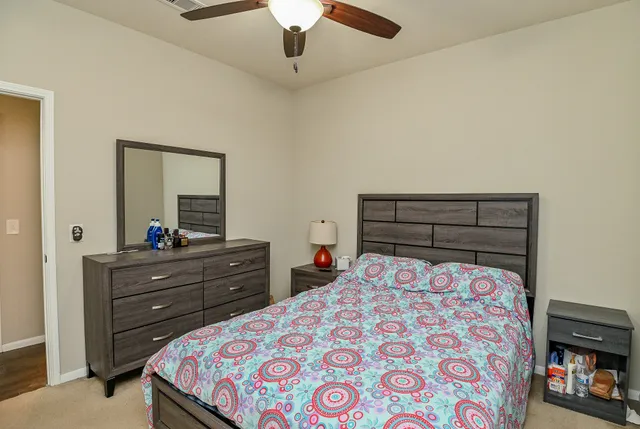 a bed room with a bed and a dresser