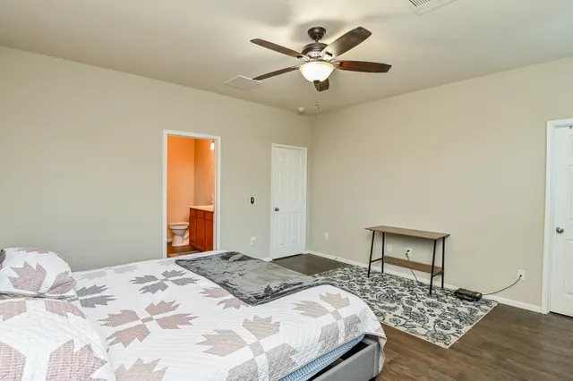 a bedroom with a large bed and a chandelier