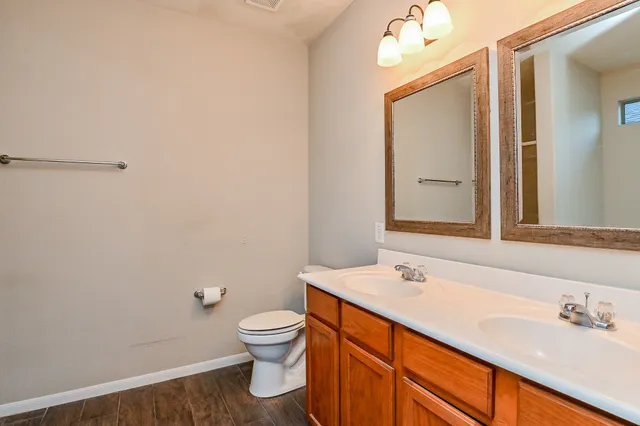 a bathroom with a sink a toilet and mirror
