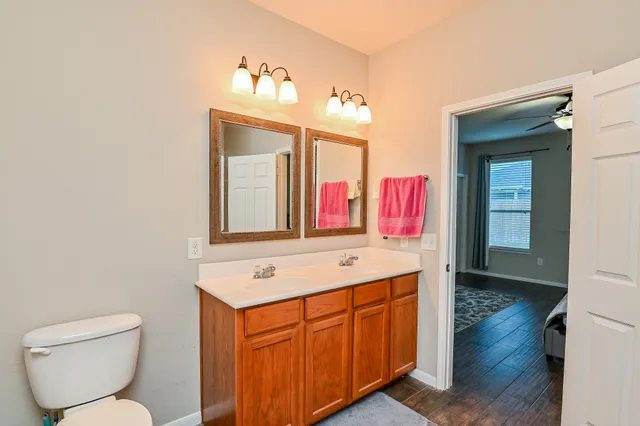 a bathroom with a sink vanity and mirror