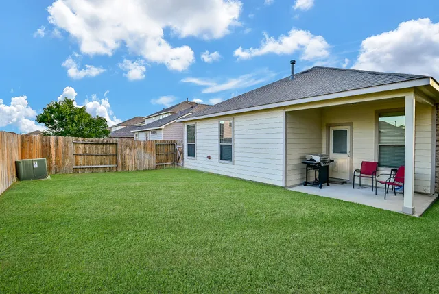 a view of a house with a backyard and porch