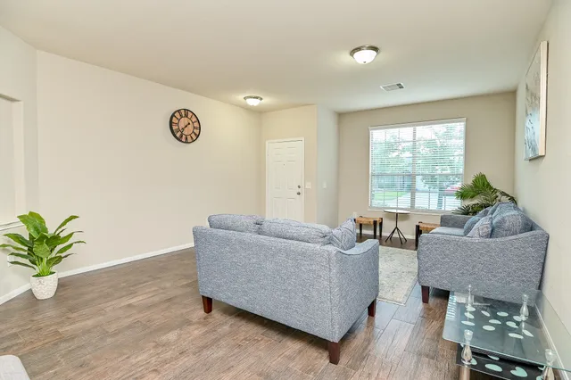 a living room with furniture and a large window