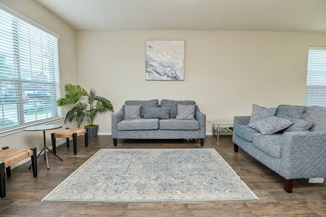 a living room with furniture and a rug