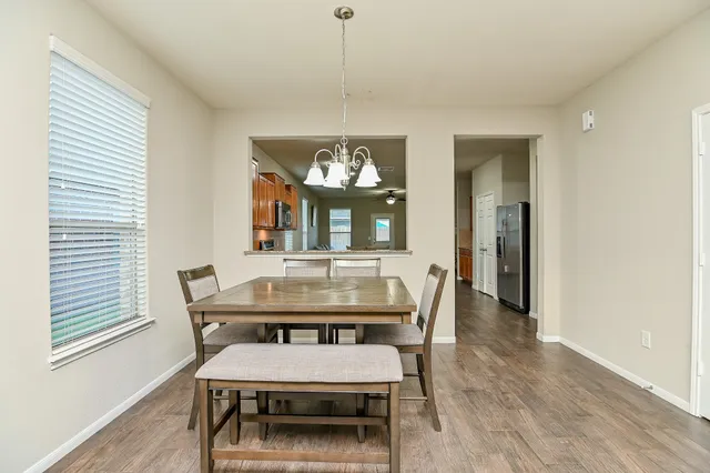 a view of a dining room with furniture and window