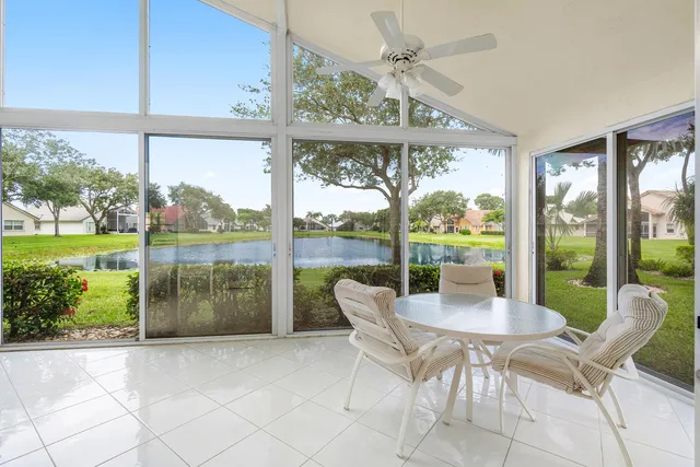 a dining room with furniture a chandelier and garden view
