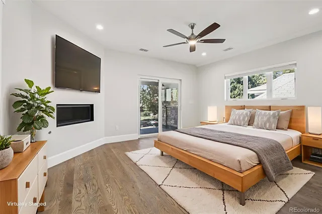 a bedroom with a large bed window and a flat screen tv