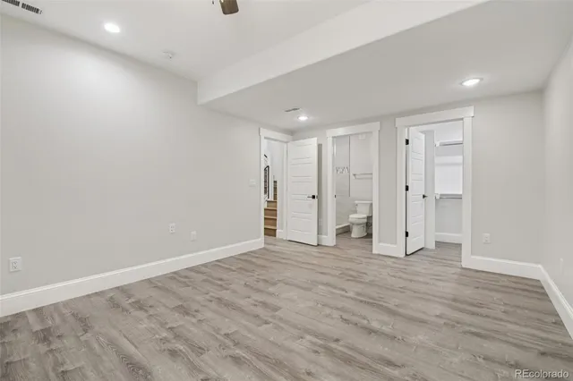 a view of empty room with wooden floor