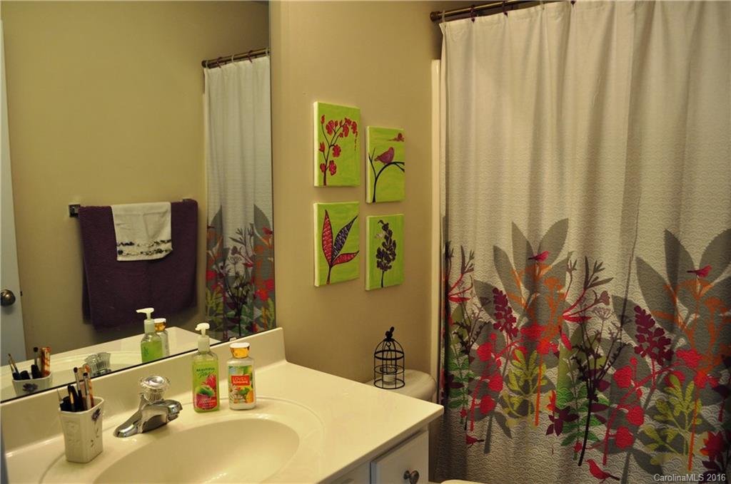 944 Copperstone Lane, Unit 165 Fort Mill, SC 29708 - Photo 14 of 18 a bathroom with a sink mirror and vanity