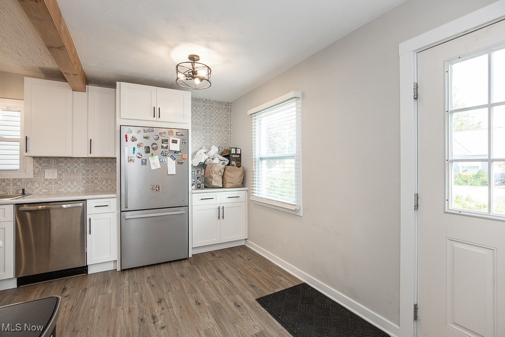 5607 Ridgewood Avenue Parma, OH 44129 - Photo 5 of 23 Kitchen with light hardwood / wood-style flooring, a wealth of natural light, white cabinets, and stainless steel appliances