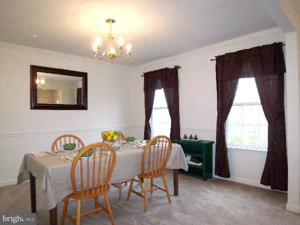 176 Shelby Road Inwood, WV 25428 - Photo 11 of 30 a view of a dining room with furniture and a chandelier