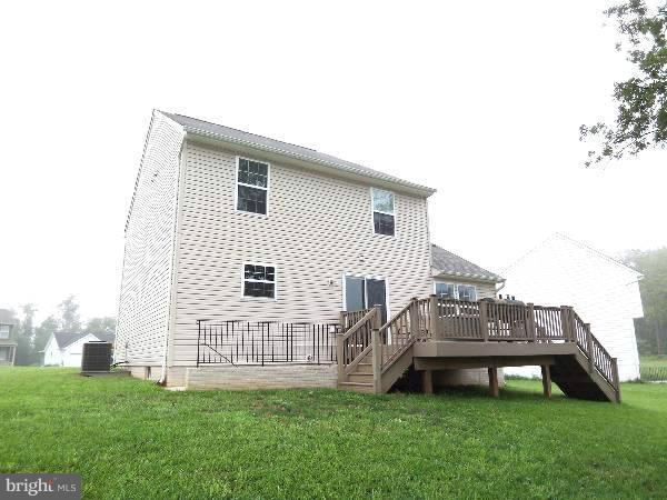 176 Shelby Road Inwood, WV 25428 - Photo 13 of 30 a view of a house with a yard and deck