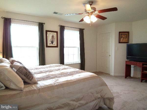 176 Shelby Road Inwood, WV 25428 - Photo 3 of 30 a bedroom with a bed and a flat screen tv