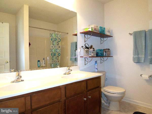 176 Shelby Road Inwood, WV 25428 - Photo 22 of 30 a bathroom with a sink vanity mirror and toilet
