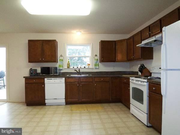 176 Shelby Road Inwood, WV 25428 - Photo 25 of 30 a kitchen with granite countertop a stove top oven sink and cabinets