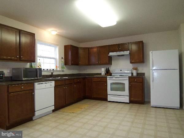 176 Shelby Road Inwood, WV 25428 - Photo 29 of 30 a kitchen with granite countertop a refrigerator stove top oven and sink