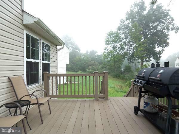 176 Shelby Road Inwood, WV 25428 - Photo 10 of 30 a view of a deck with table and chairs and wooden floor