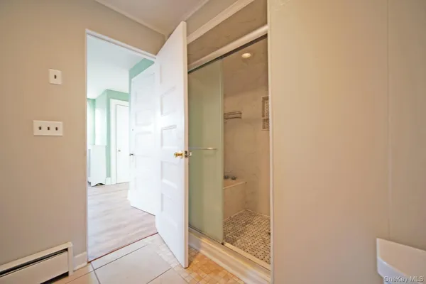 a bathroom with a glass shower door