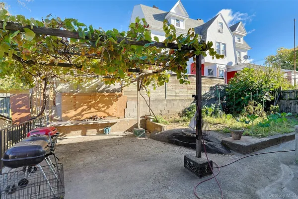 a backyard of a house with outdoor seating