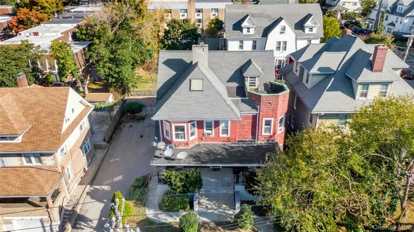 an aerial view of a house with a yard and potted plants