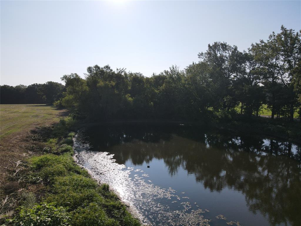 a view of a lake in between two of trees