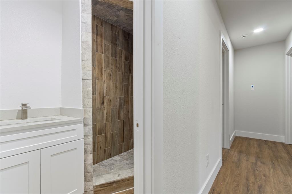 2029 Lynnhaven Road Fort Worth, TX 76103 - Photo 10 of 13 White vanity with integrated sink and brushed nickel faucet
