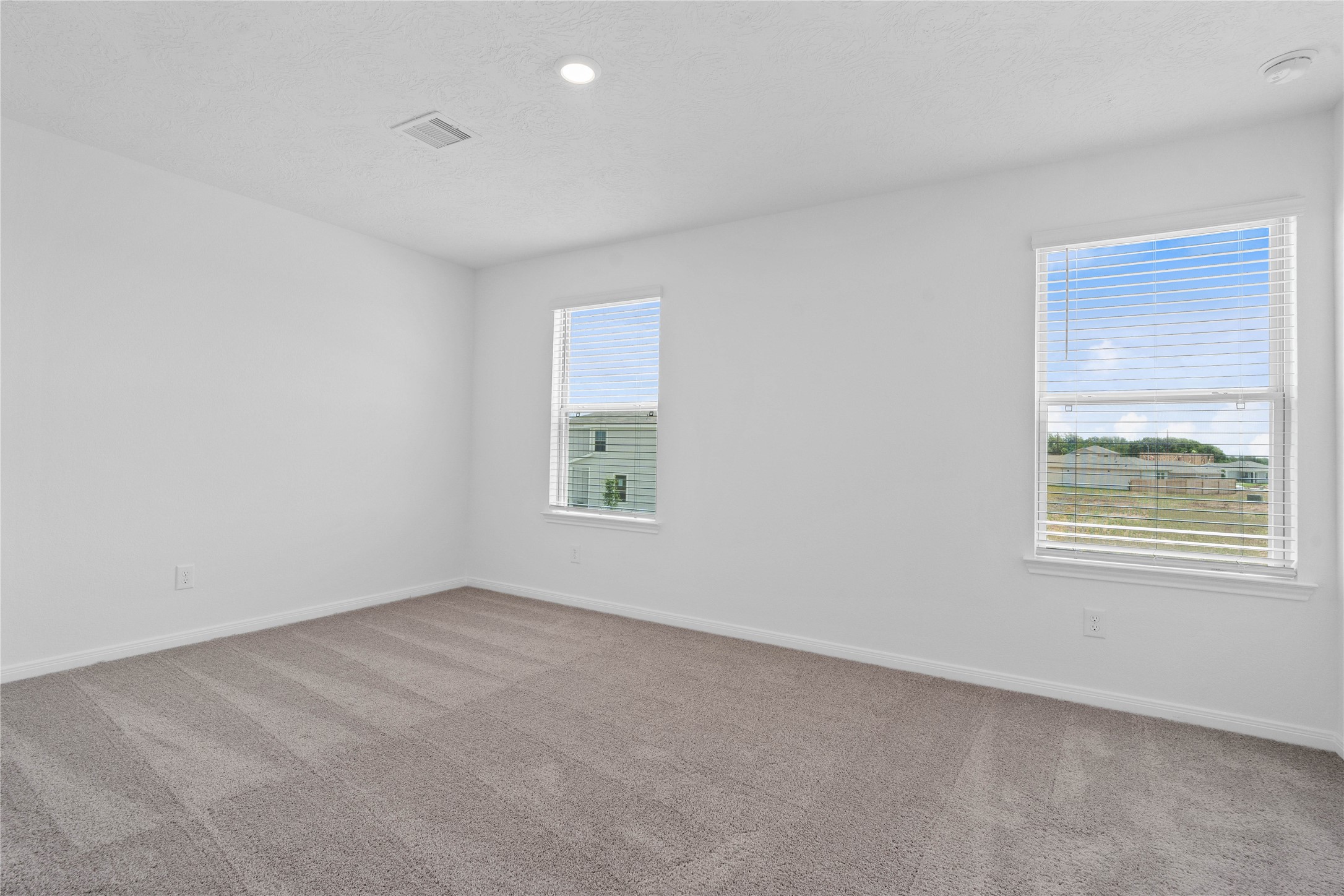 7210 Brooklea Road Beasley, TX 77417 - Photo 22 of 32 Well appointed secondary bedroom that features plush carpeting, neutral paint tones, recessed lighting, large windows with fitted blinds, and a generously sized closet.