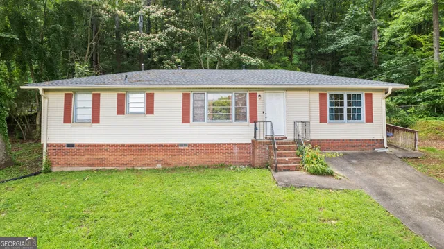 a front view of a house with a garden