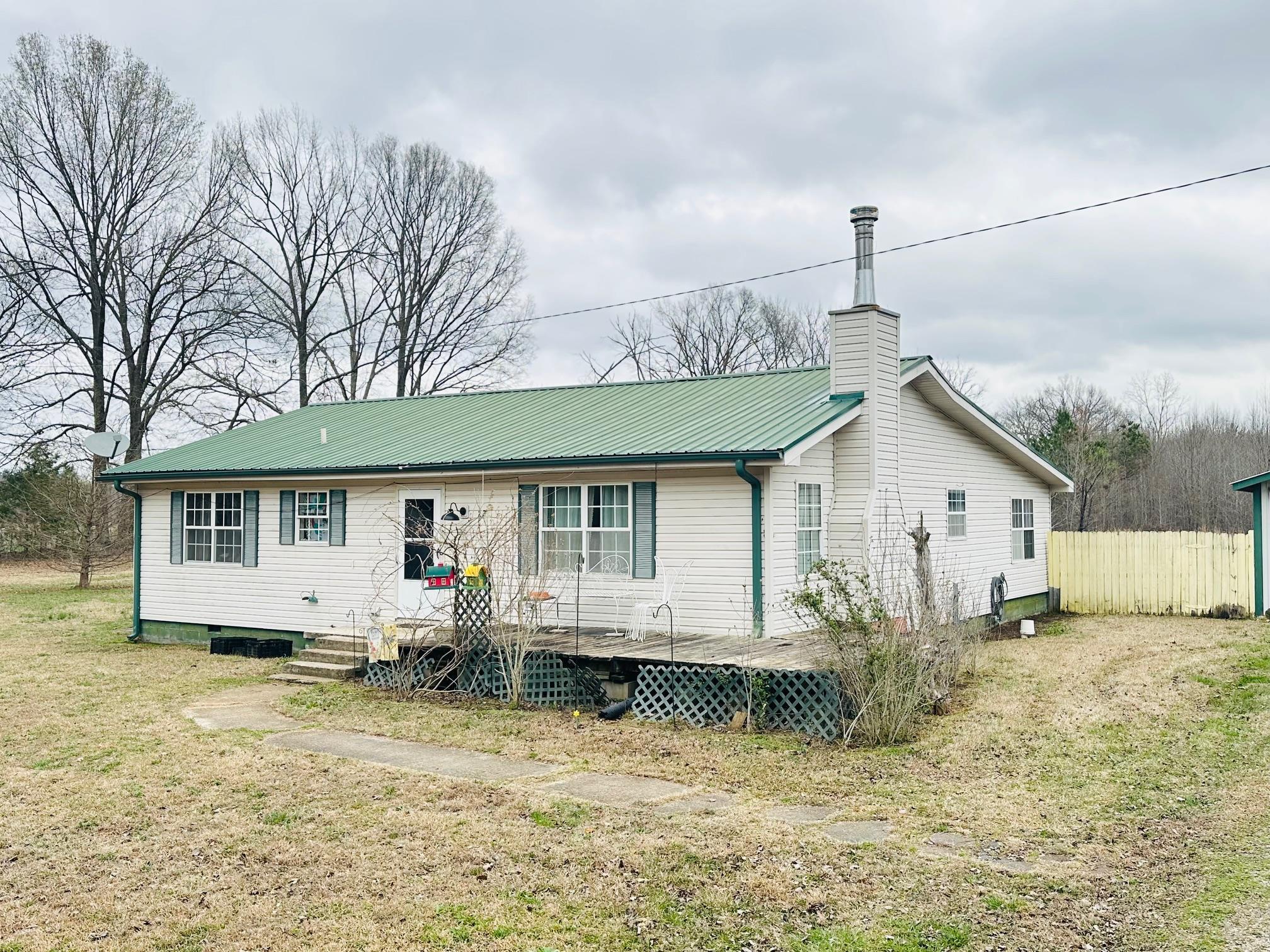 275 Fritton Spur Road Middleton, TN 38052 - Photo 9 of 31 Rear view of property featuring a metal roof and a chimney