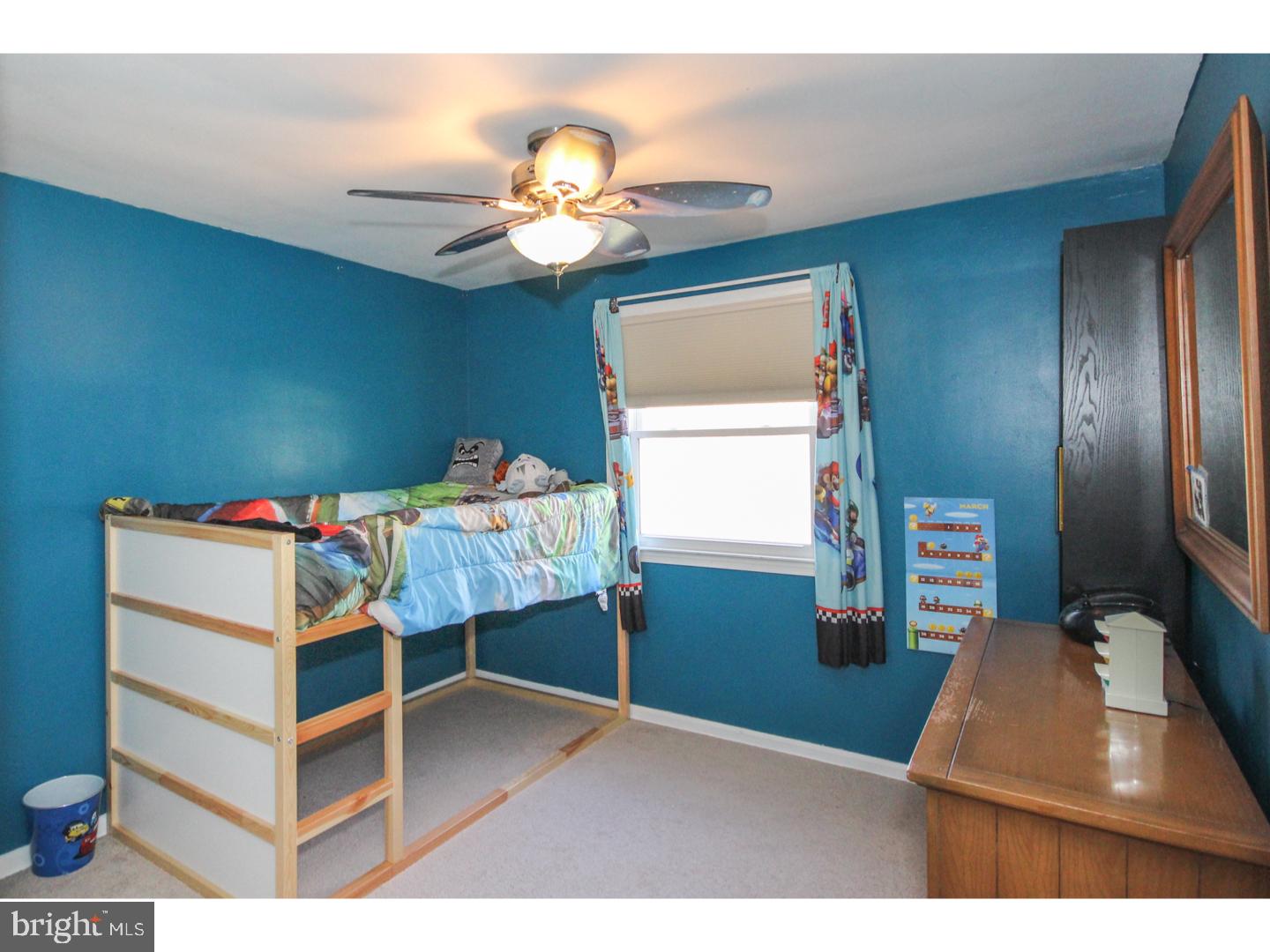 1010 Glen Road Wallingford, PA 19086 - Photo 14 of 20 a bedroom with a bed and a chandelier
