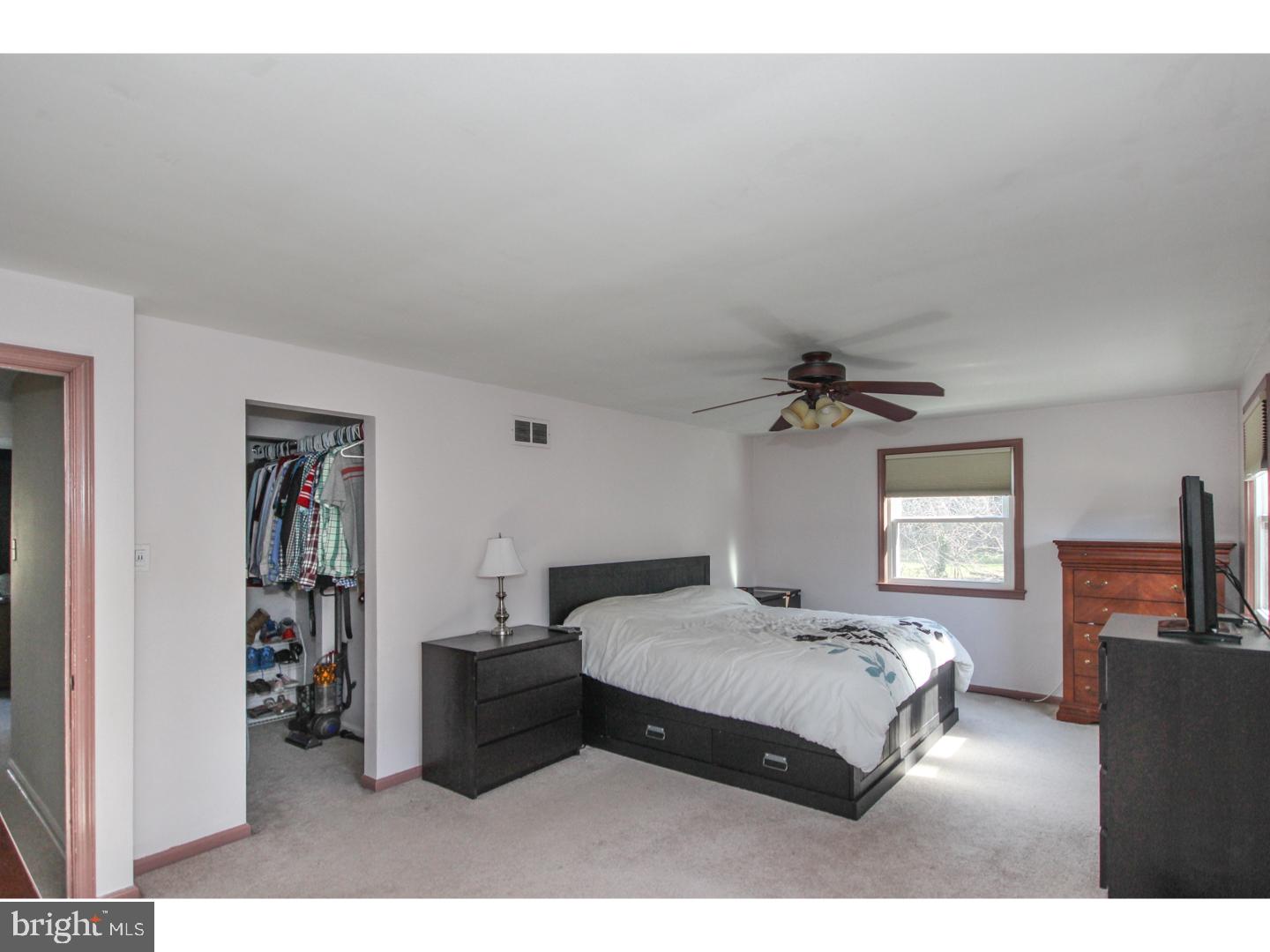 1010 Glen Road Wallingford, PA 19086 - Photo 10 of 20 a bedroom with a bed a couch and a flat tv screen on the dresser