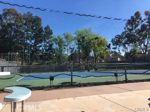 a view of a park with of a house in the background