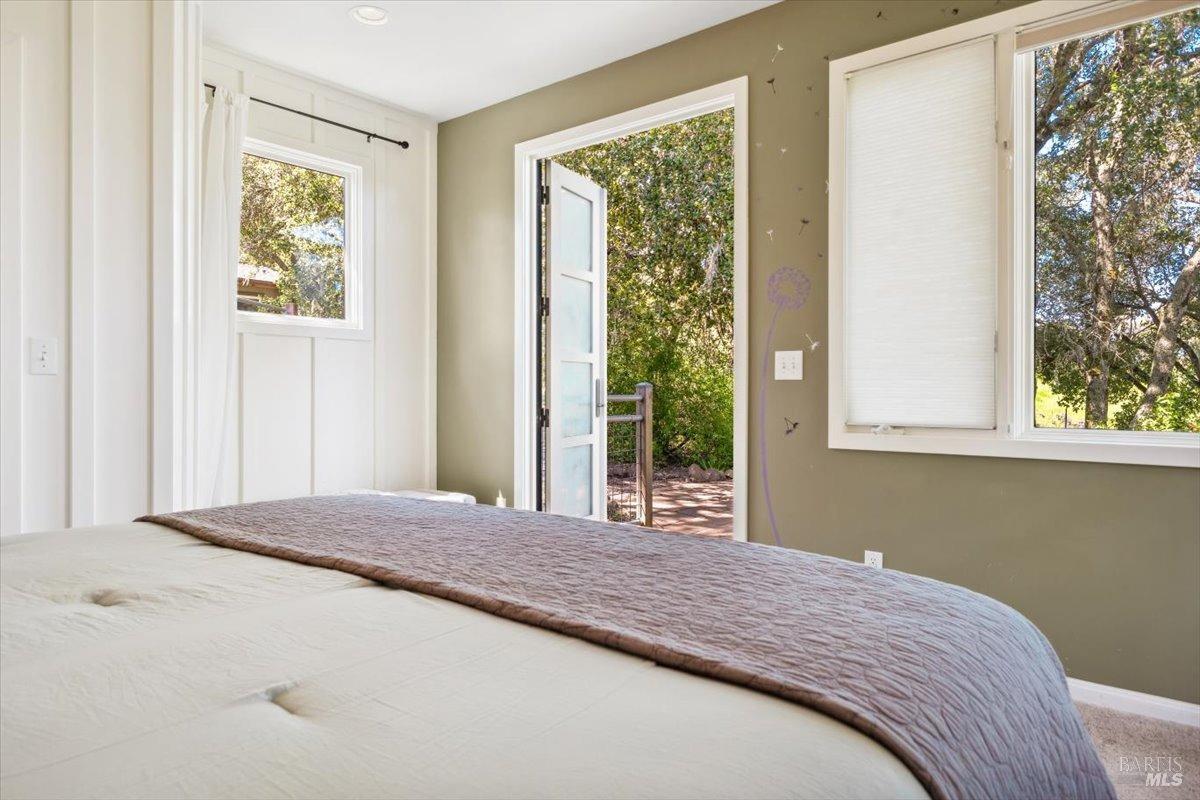 4820 Bennett Valley Road Santa Rosa, CA 95404 - Photo 22 of 65 Main house primary suite/bedroom #2 with french doors leading out to a private deck with hot tub under the oaks.