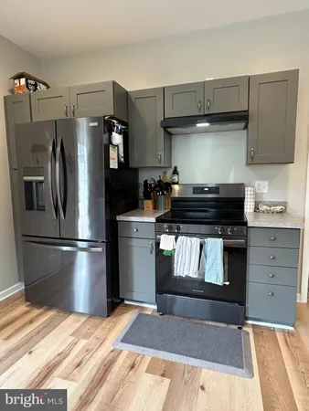 a kitchen with a refrigerator stove and microwave
