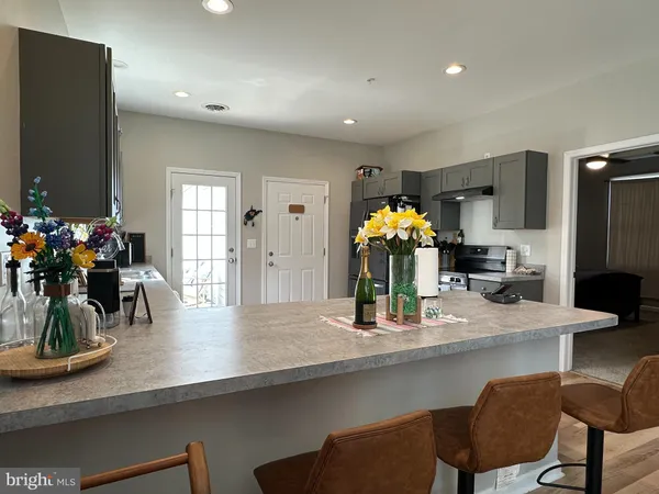 a kitchen with counter space dining table and chairs