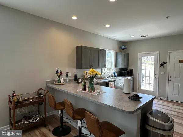 a kitchen with stainless steel appliances granite countertop a sink stove and cabinets